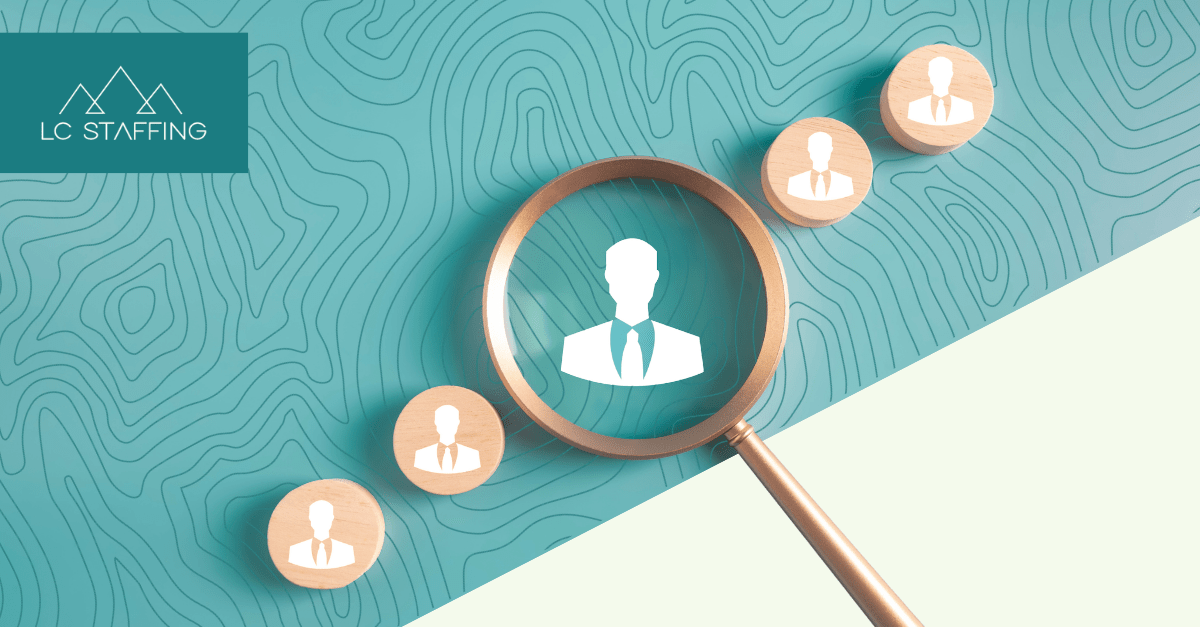Magnifying glass highlighting a candidate among others, representing how regional recruiting firms vs national agencies approach finding the right hire.