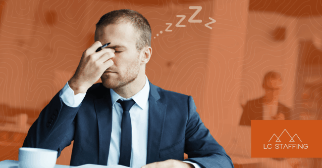 Exhausted office worker at his desk illustrating the need for contingent labor to reduce employee burnout.