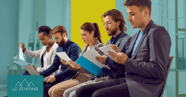 Three professionals reviewing job placement data with a staffing agency in Montana.